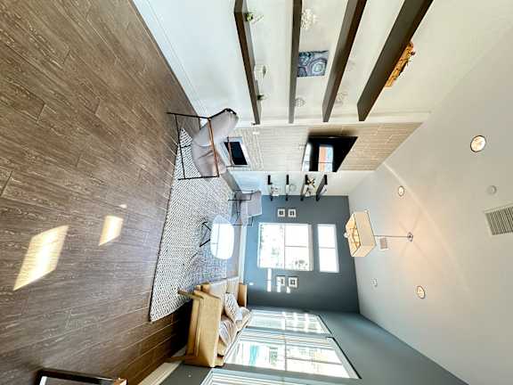 a large open living room with a staircase and a modern design at The Bryant Apartments at Yorba Linda, California