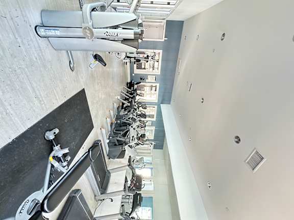 a view of ellipticals and treadmills in a spacious gym at The Bryant Apartments at Yorba Linda, Yorba Linda, 92887