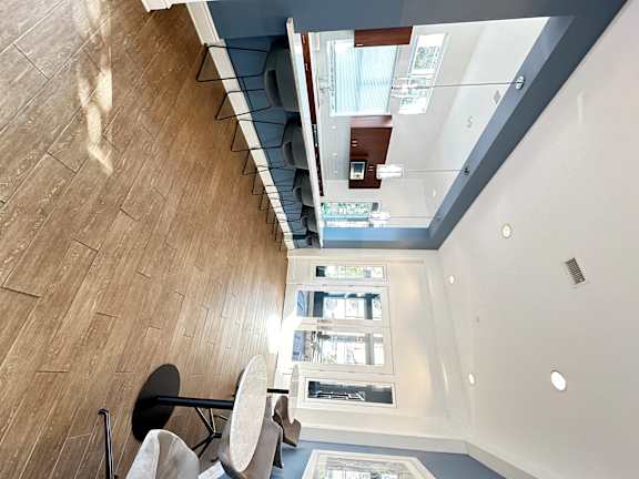 a living room with a glass floor and a table and chairs at The Bryant Apartments at Yorba Linda, Yorba Linda