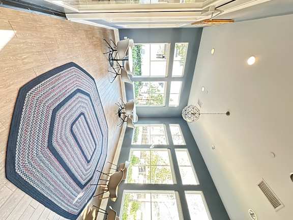 a sitting area in a clubhouse with rug and chairs at The Bryant Apartments at Yorba Linda, Yorba Linda, CA
