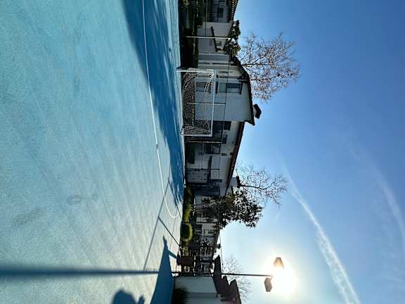 a view of the side of a building and sports court