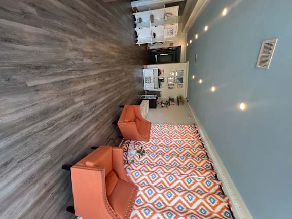 A kitchen with a wooden floor and a patterned ceiling.