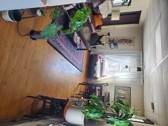 A room with a couch, a table, and a window.