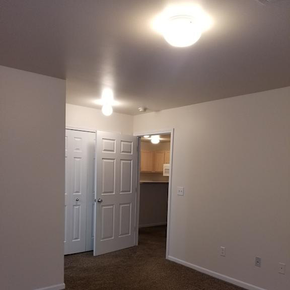 A white staircase with a light on the left side.
