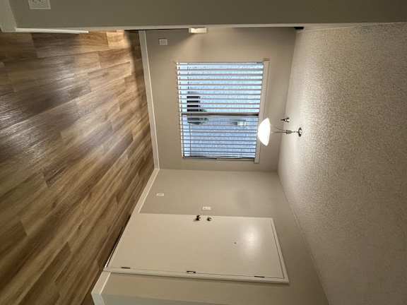 a view of a bathroom with a window and a mirror