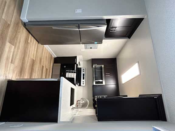 a kitchen with a counter top and a stove and a microwave