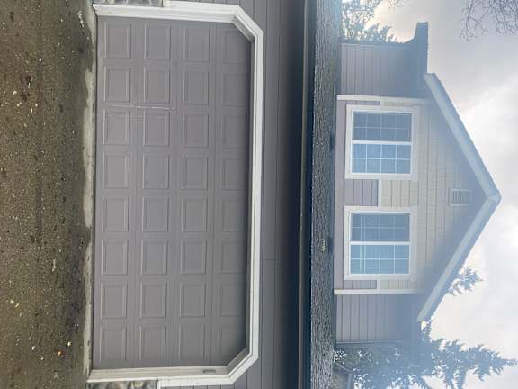 A grey garage door is open.