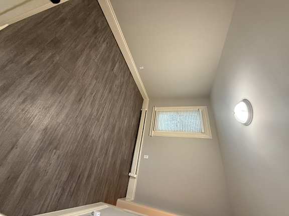 A small window with blinds is on the wall.