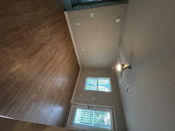 A room with a skylight and a wooden ceiling.