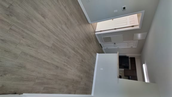 a view from the top of a room looking down at a kitchen and a floor