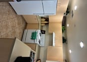 Thumbnail 3 of 14 - A kitchen with a white fridge and wooden cabinets.