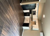 Thumbnail 30 of 48 - A wood floor with a white cabinet and drawers.