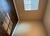 Thumbnail 33 of 48 - A room with a window and wooden flooring.