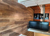 Thumbnail 42 of 48 - A kitchen with a black TV mounted above a white fridge.