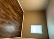 Thumbnail 44 of 48 - A room with a window and a wooden wall.