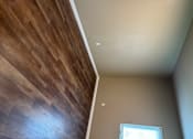 Thumbnail 45 of 48 - A room with a window and wooden flooring.