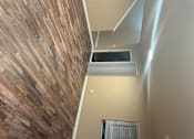 Thumbnail 19 of 48 - A staircase with a wooden floor and a wall with a window.