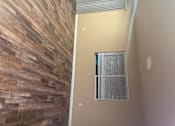 Thumbnail 20 of 48 - A room with a window and a wooden wall.