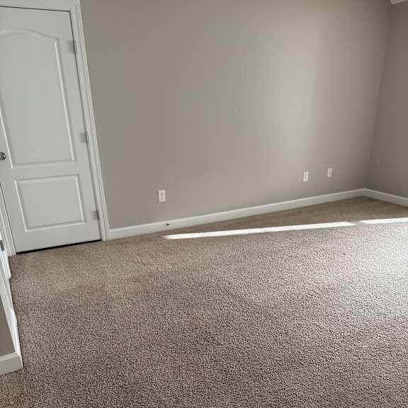 A white door with a brown wall behind it.