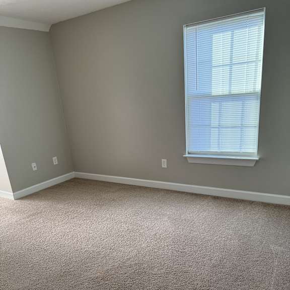 A window with blinds is on the wall.