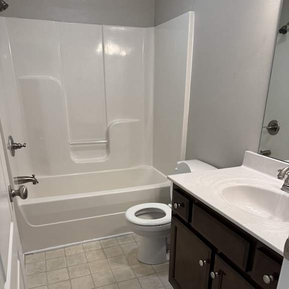 A white bathroom with a toilet and sink.