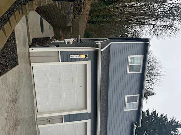 A house with a garage door opener attached to the side of it.