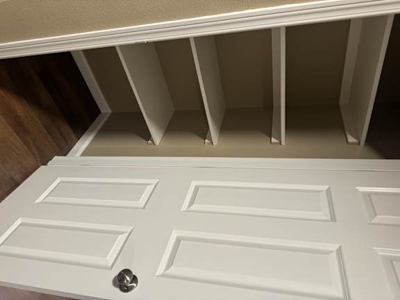 A white ceiling with a square pattern and a silver bolt in the middle.