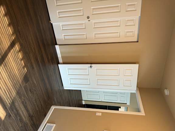 A white door is on the bottom and a white door with a window above it.