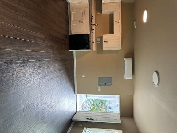 A small room with a TV and a cabinet.