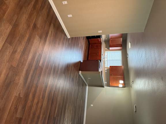 A room with a wooden wall and a white table.