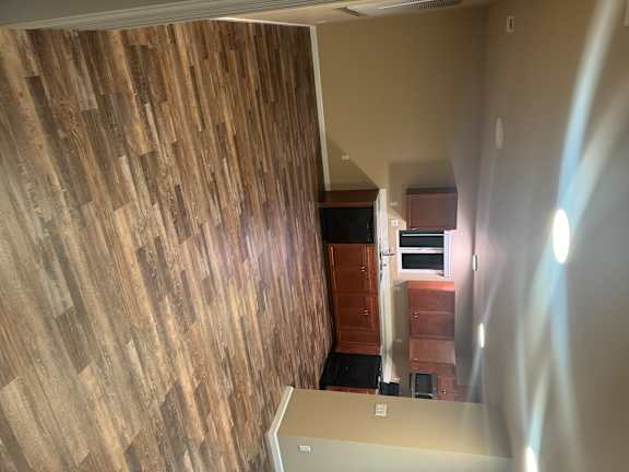A wall of wood planks with a light shining on it.