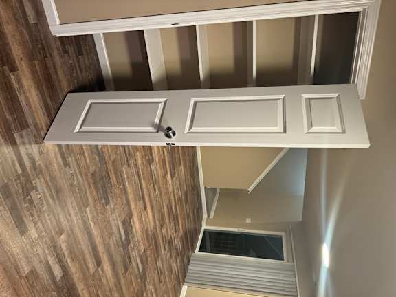 A white door with a handle is open.