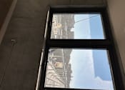 Thumbnail 15 of 18 - A view of a street from a window in a building.