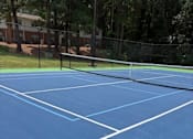 Thumbnail 13 of 33 - A blue running track with white lines.