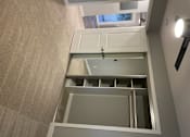 Thumbnail 11 of 19 - A white cabinet with a glass door is open.