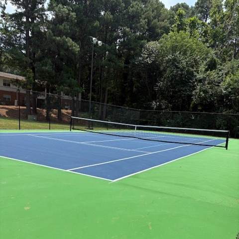 A tennis court with a blue and green surface.