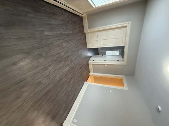 A room with a wooden wall and a skylight.