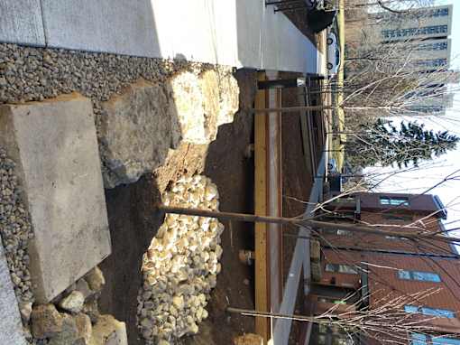 A wall with a stone and concrete base.