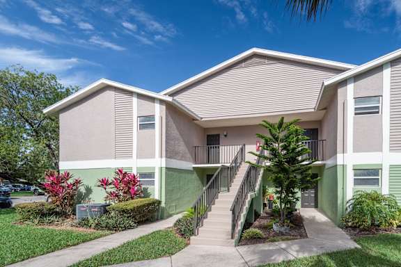 Two story at apartment building with lush landscaping.