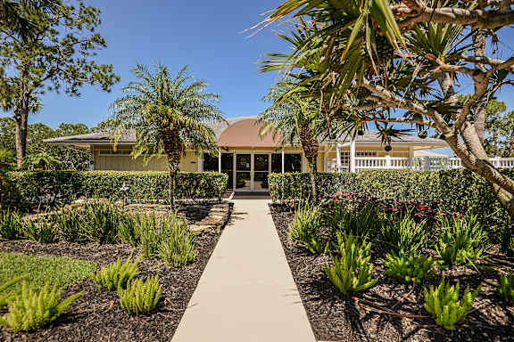 Club house with lush landscaping.