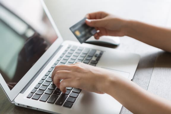 person-writing-laptop-with-credit-card at Twenty2 West, Florida, 33155