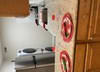 Thumbnail 15 of 15 - A kitchen with a stove and a wall with red and white circles on it.
