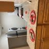 A kitchen with a stove and a wall with red and white circles on it.