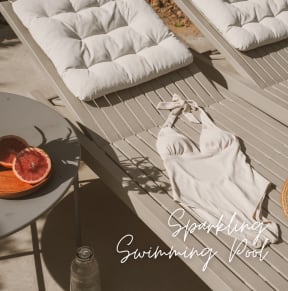 a table with a towel and a plate of fruit on a bench