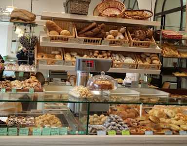 A bakery display case filled with a variety of baked goods.