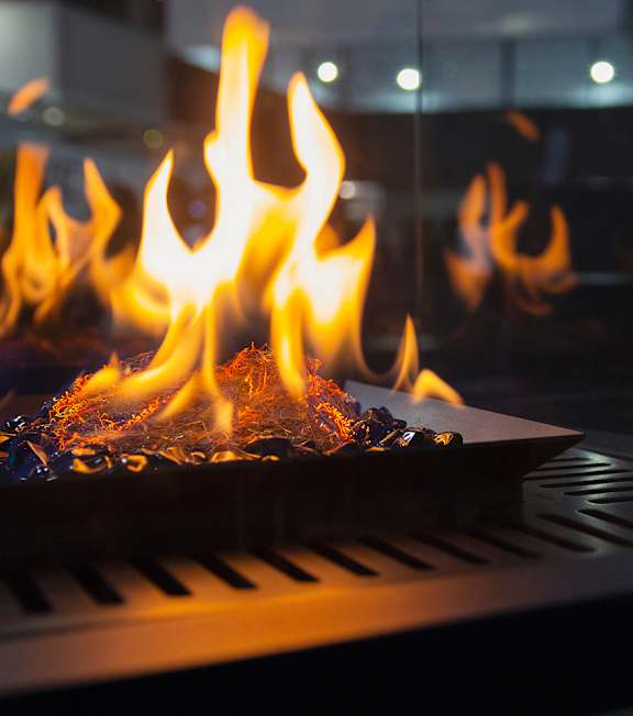 A close up of a fire burning in a fireplace.