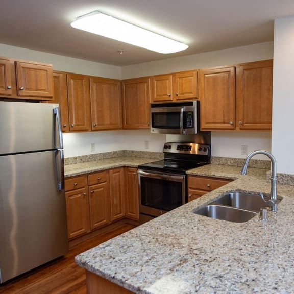 a kitchen with granite counter tops and stainless steel appliances