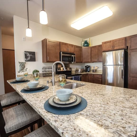 a kitchen with granite counter tops and stainless steel appliances