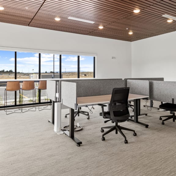 an open office space with desks and chairs and large windows at Yellowstone Landing, Belgrade, 59714