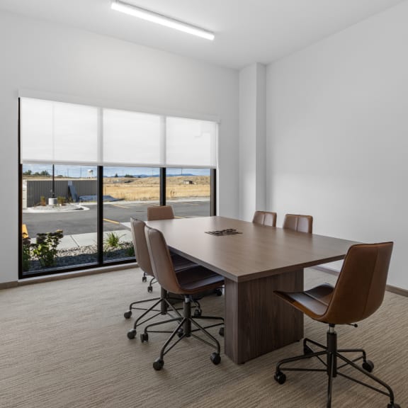 a conference room with a table and chairs and a window at Yellowstone Landing, Belgrade, MT, 59714